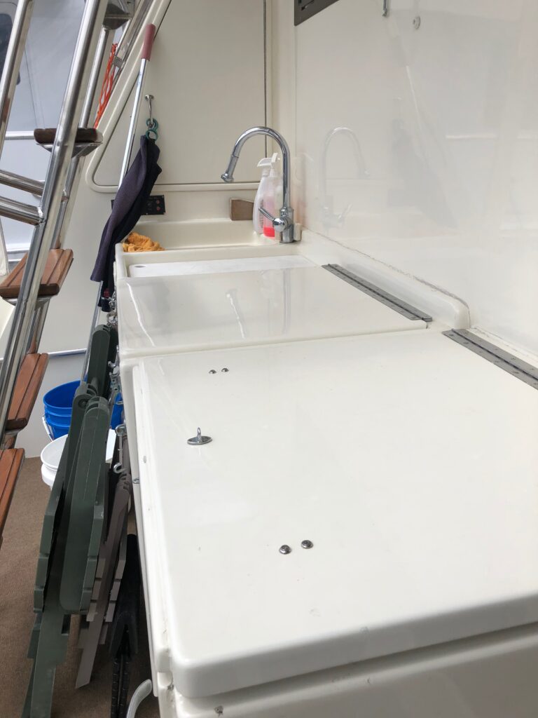 Work Station, Fridge/Freezer, Sink, Storage, and access to Engine Room.
